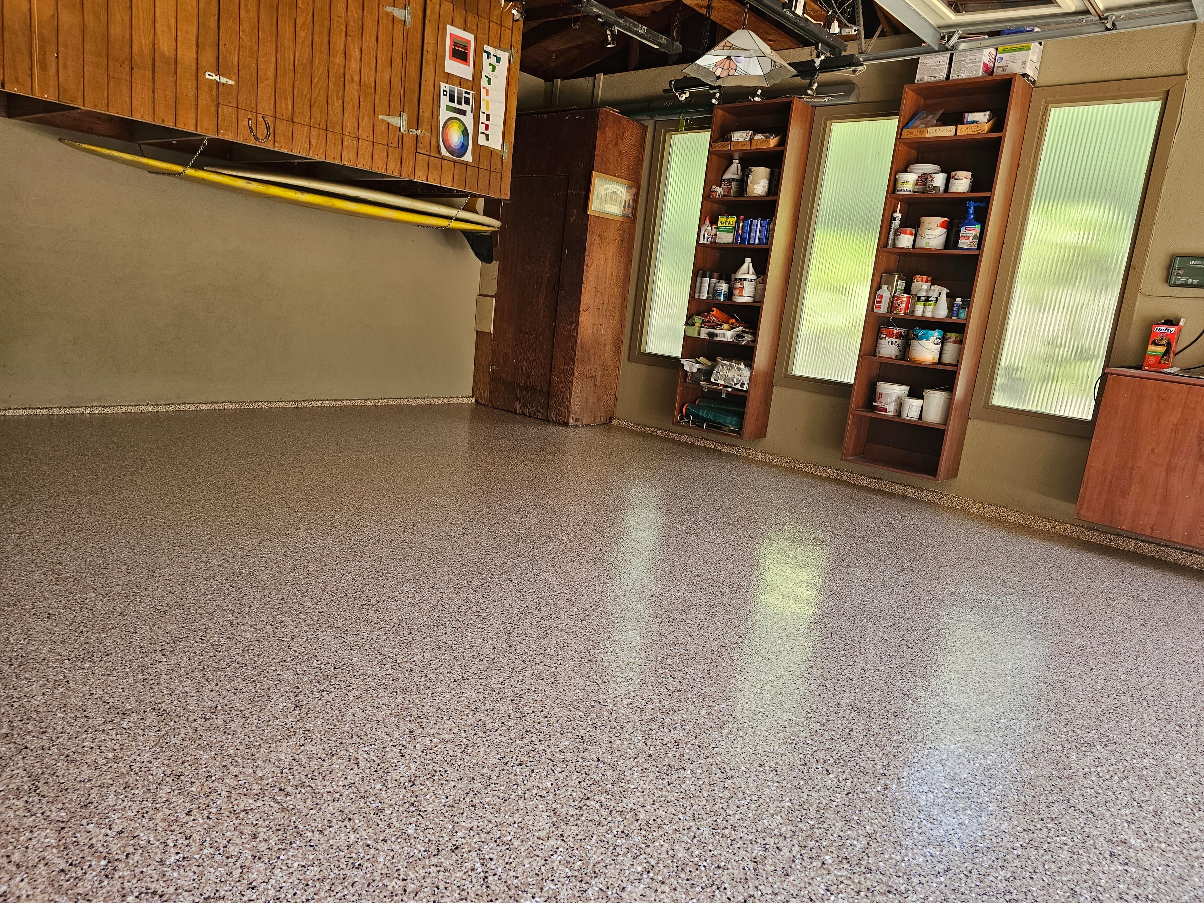 Epoxy flake garage floor with wooden storage cabinets — completed project