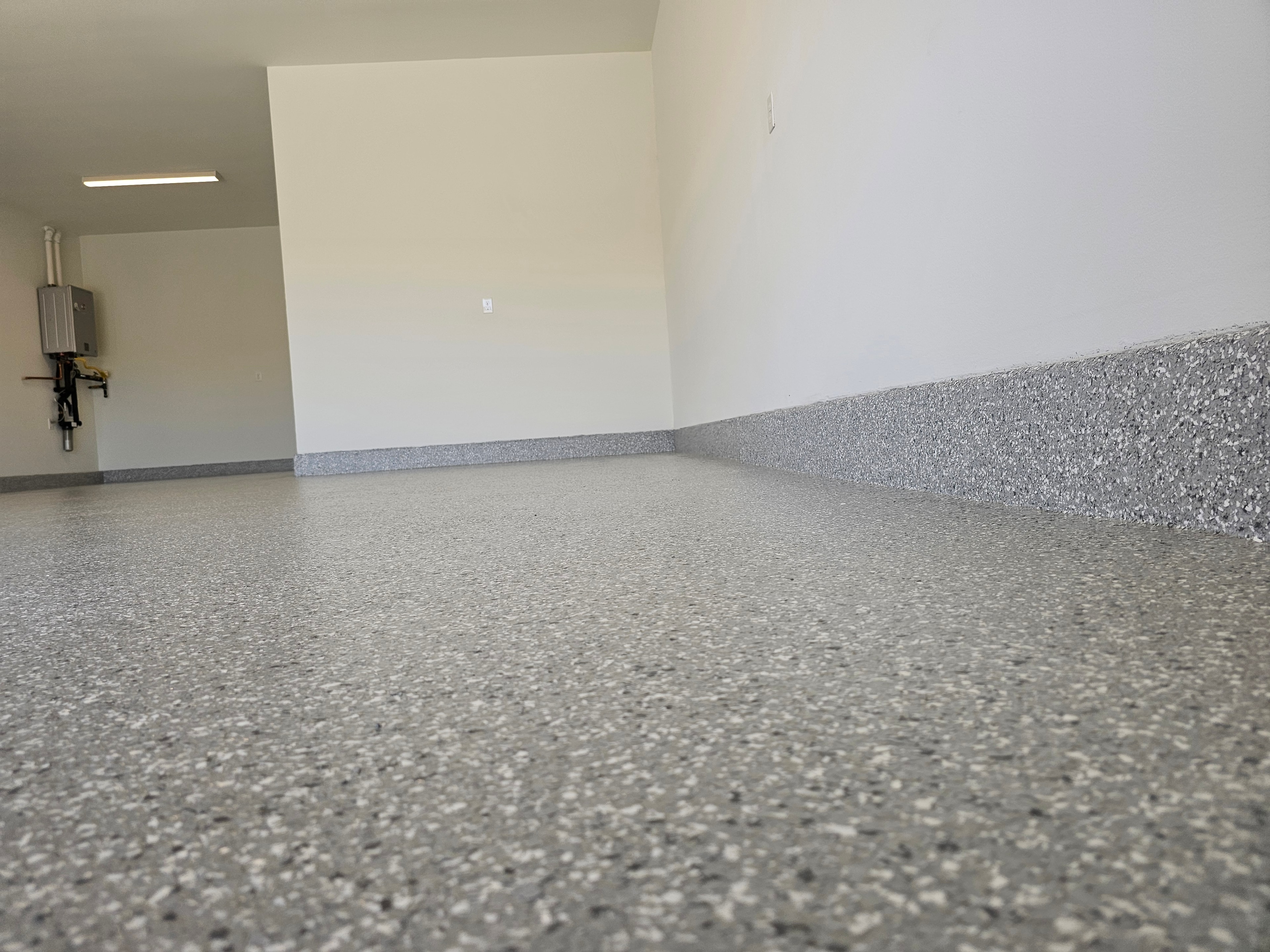 Grey blended flake epoxy garage floor — low angle view showing texture