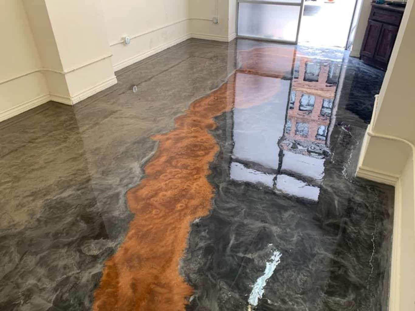 Metallic epoxy floor — flowing copper and dark grey 3D design