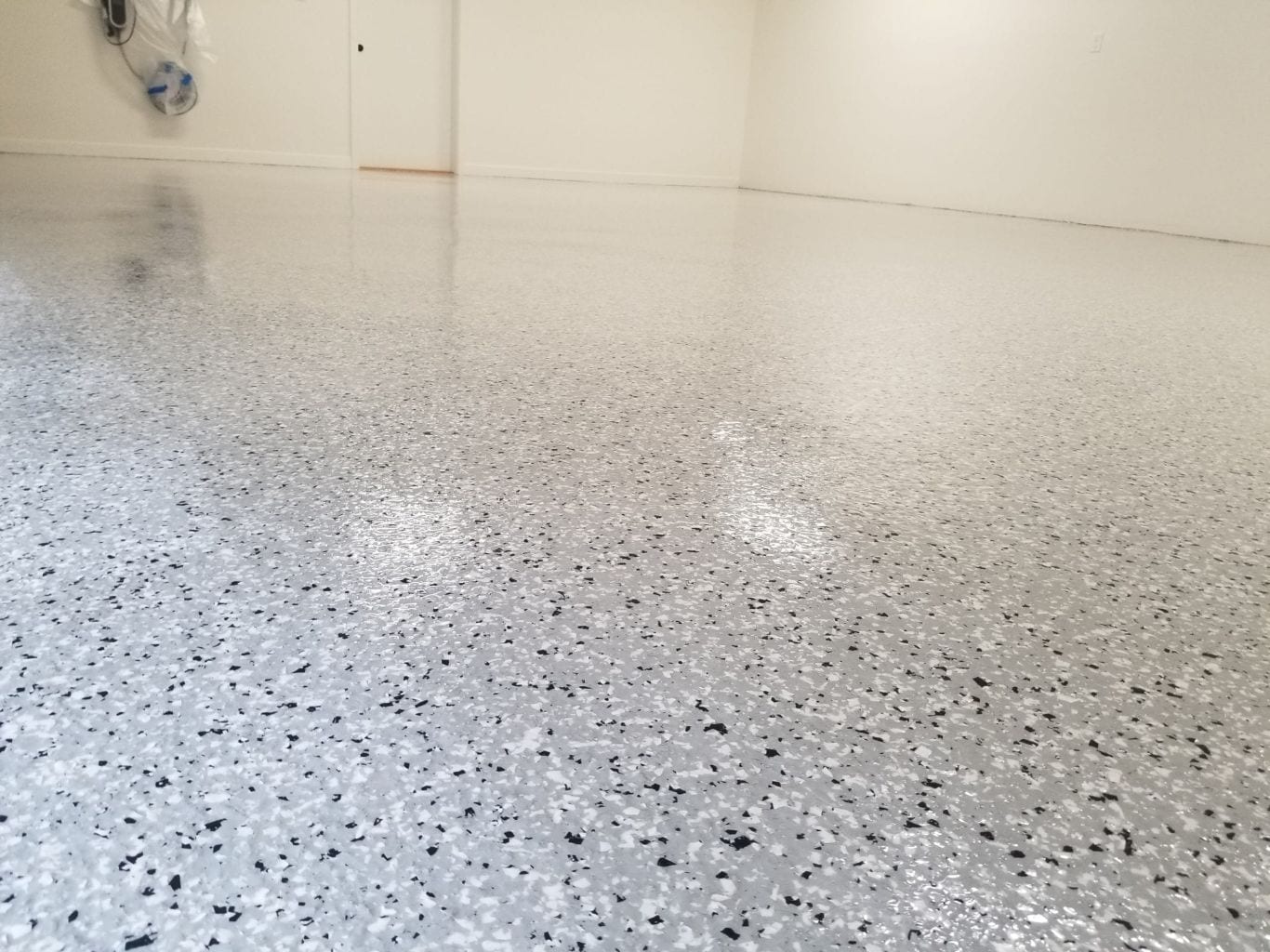Light grey blended flake epoxy garage floor — polished finish
