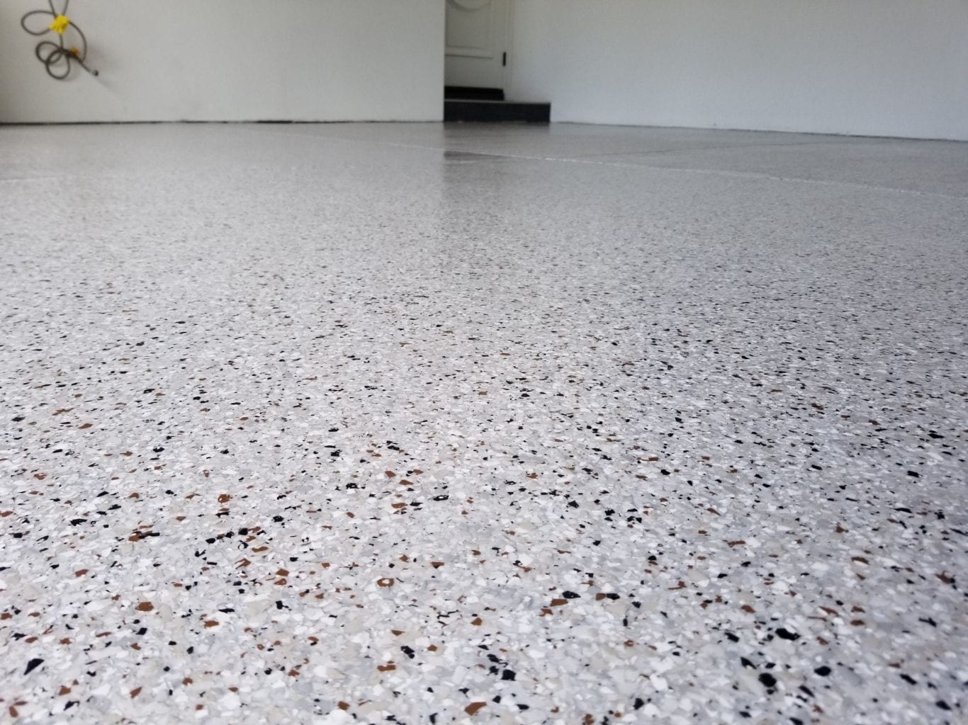 California grey blended flake epoxy floor — low angle view