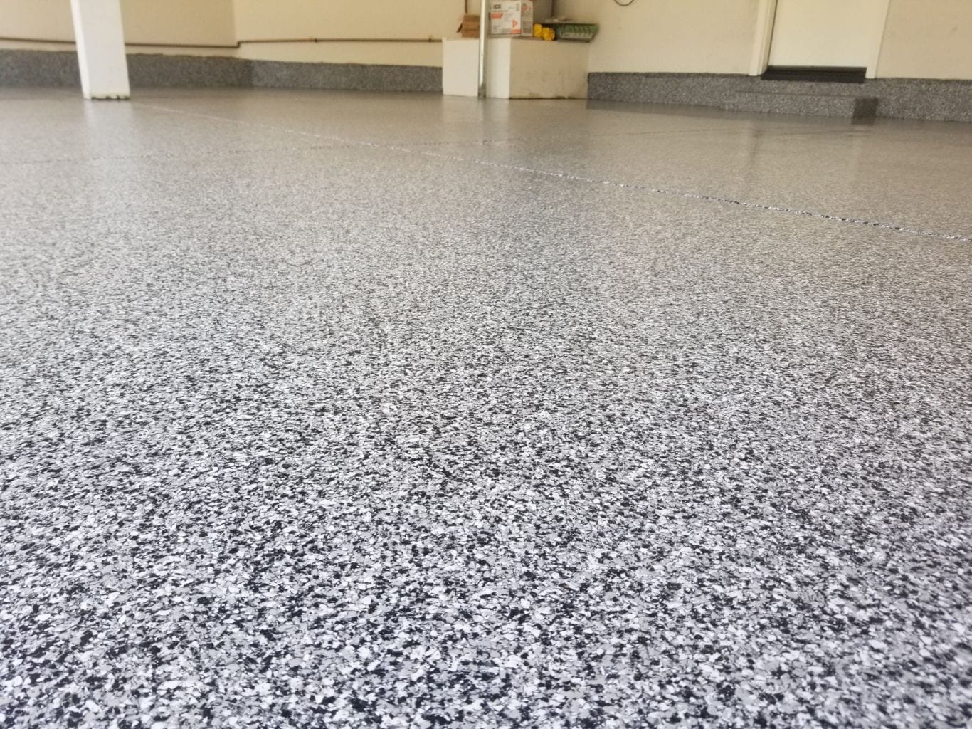 Tuxedo blended flake epoxy garage floor — grey and white finish
