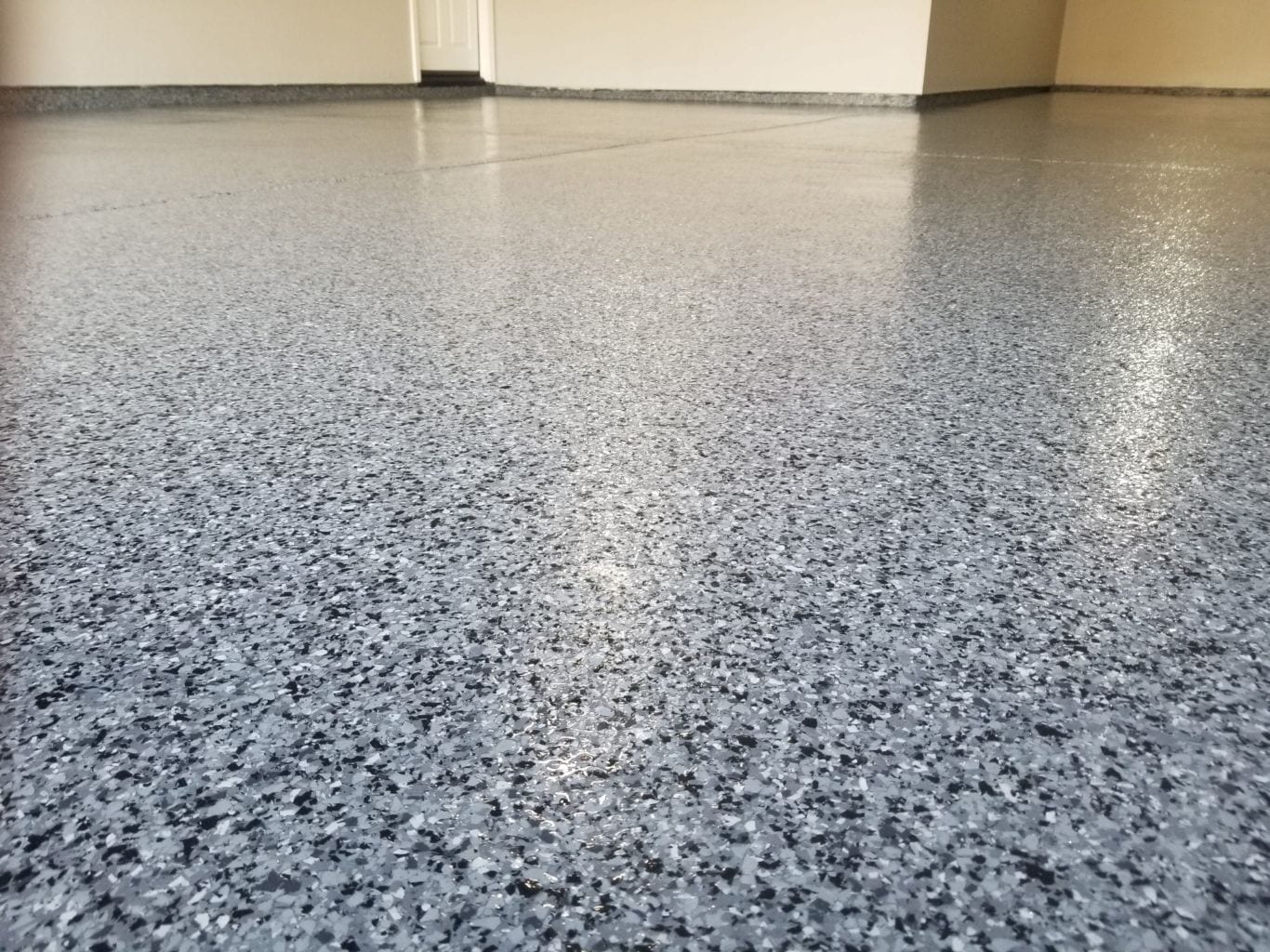 Midnight blended flake epoxy floor — dark polished finish