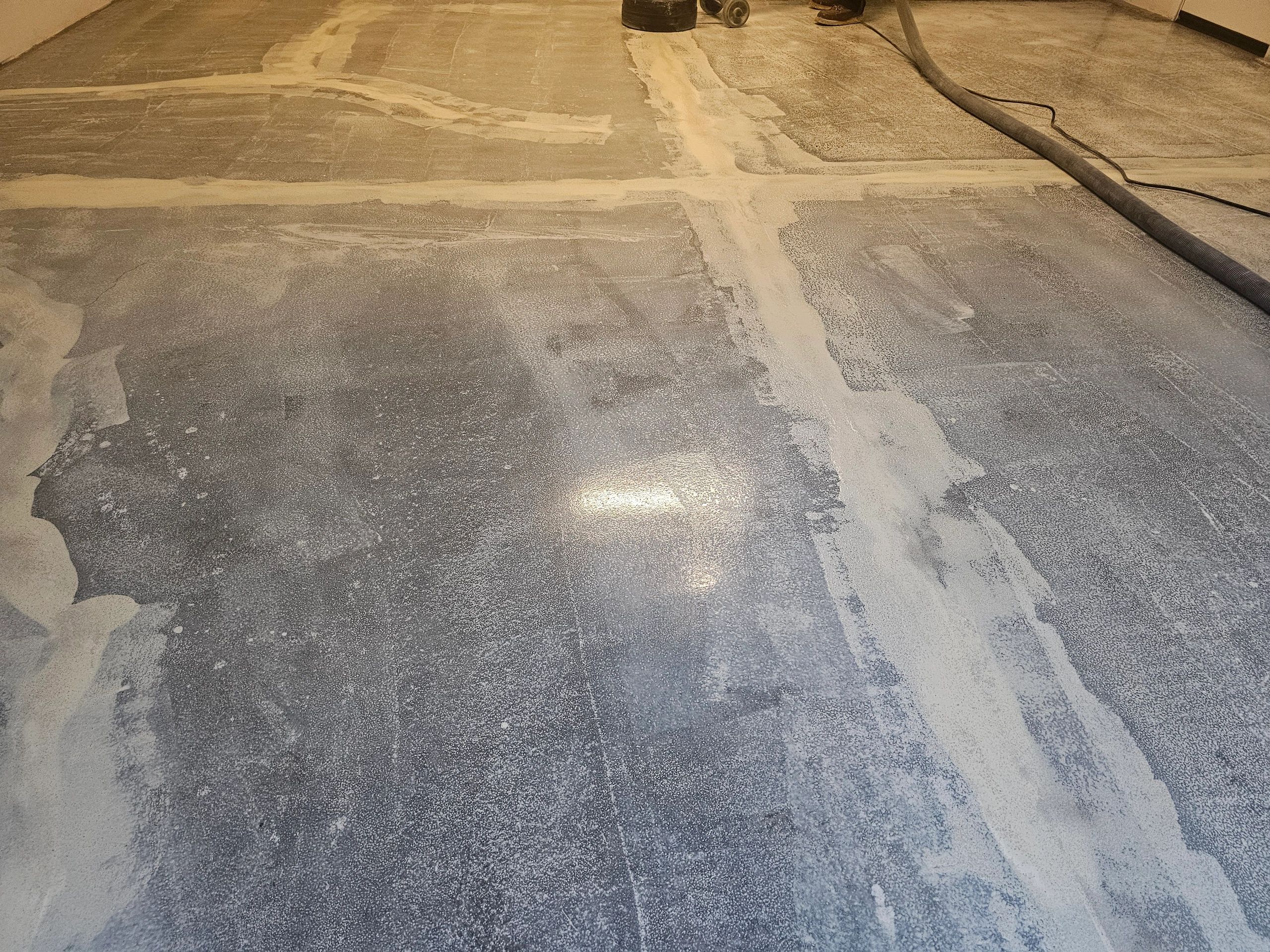 Epoxy floor installation process — densifier application on concrete slab